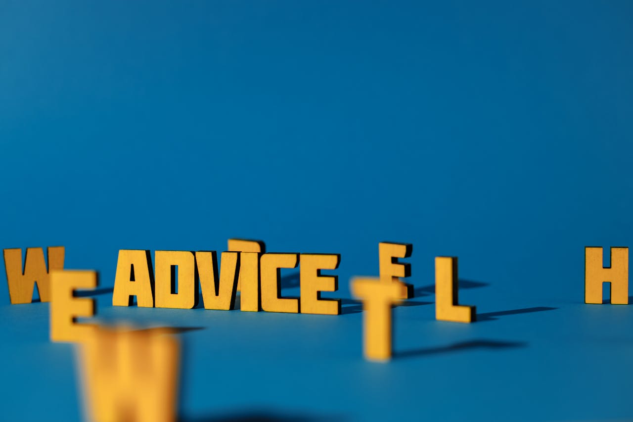 services-img Wooden letters spelling 'Advice' on a blue background providing conceptual copyspace.