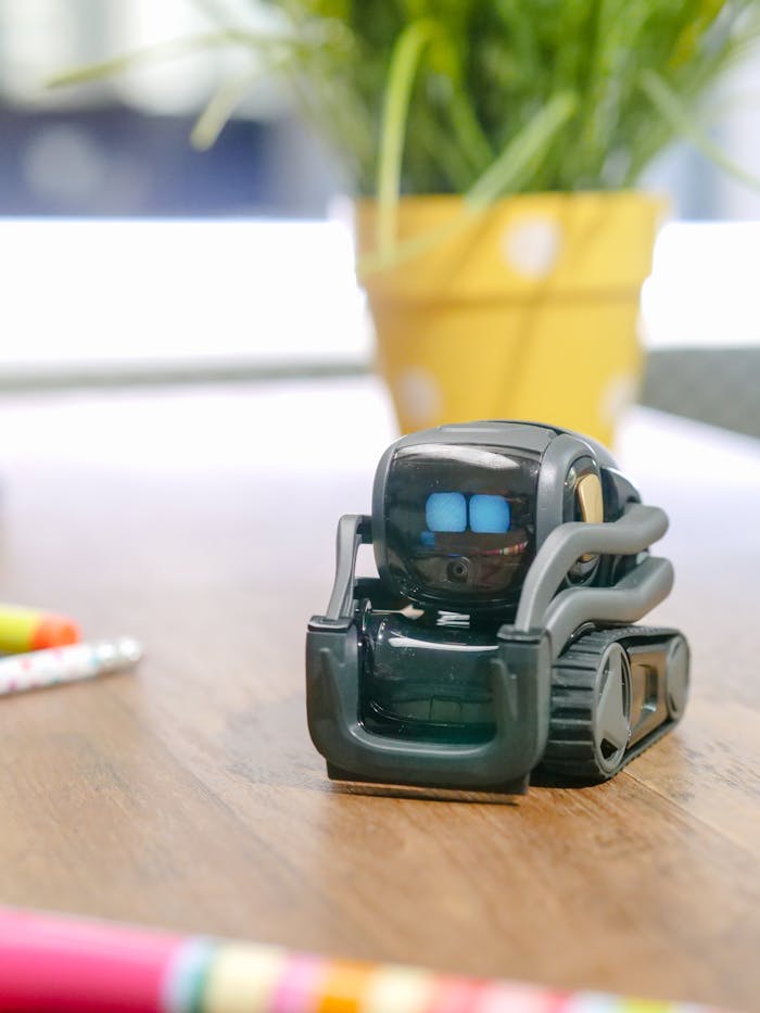 Close-up of a small robot toy on a desk, representing modern technology and innovation.