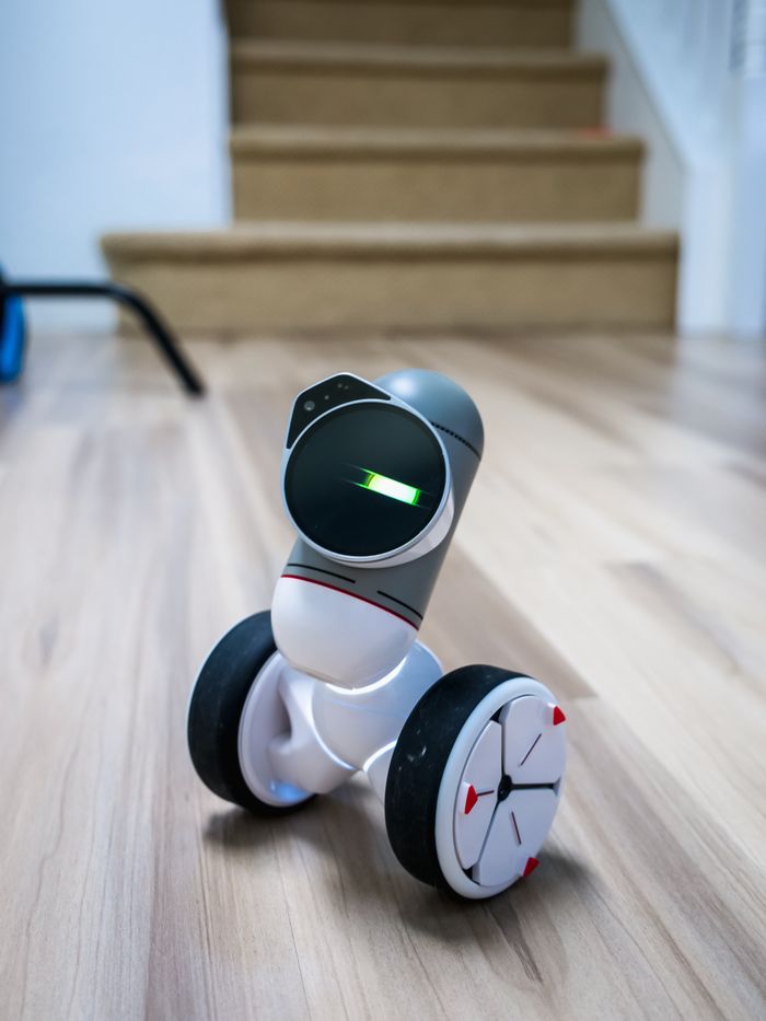 Close-up of a cutting-edge wheeled robot toy with soft focus background indoors.